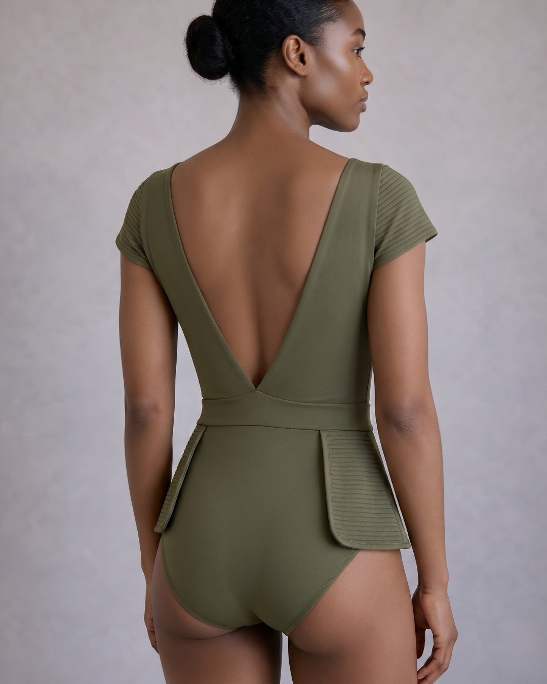 olive green Monroe peplum one-piece swimsuit with structured waist detail peplum and detailed stitching cap sleeves and deep-v back by Journey XX